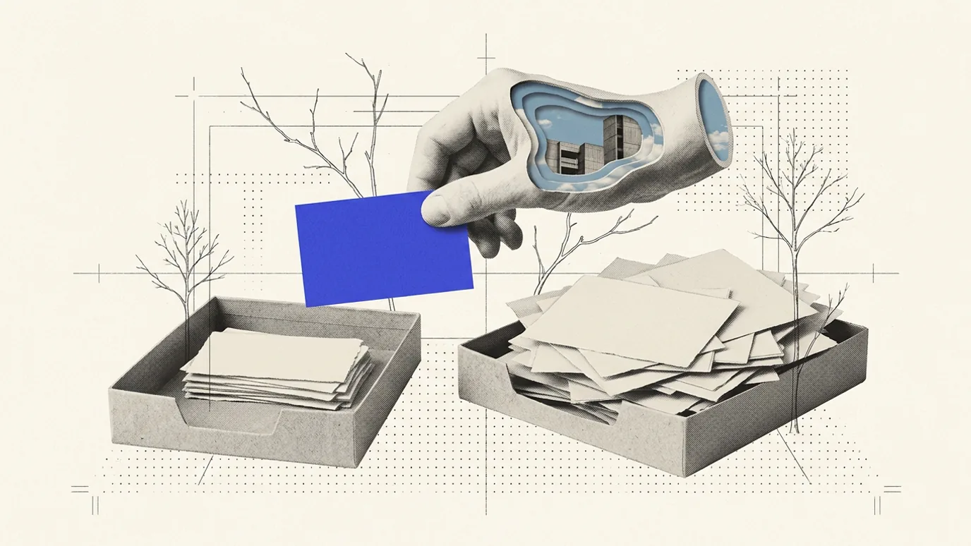 Two shallow paper trays on a dotted grid, one holding a neat stack of blank cards and the other heaped with loose blank cards, while a hollowed plaster hand above them holds a single solid blue card