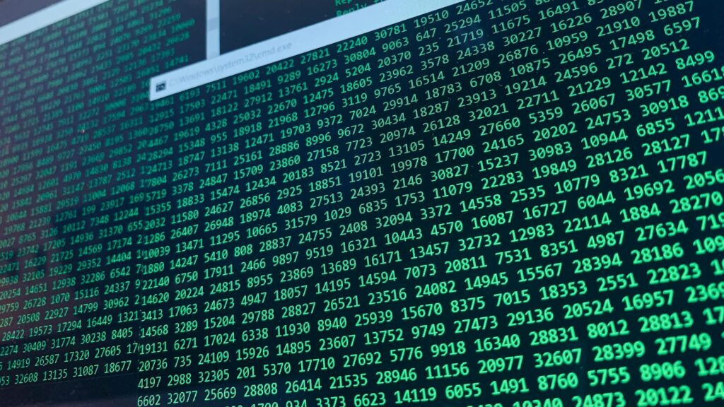 Vibrant green numbers on a computer screen, showcasing binary code and data streams - consolidating marketing data